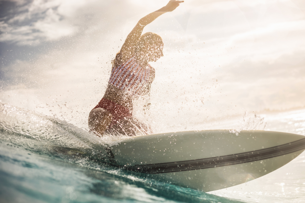 Surfer girl on a wave in the tropics and it's about surfing without fear