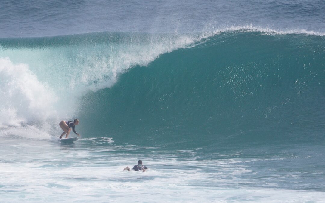 Anna Unternährer surfing a big wave in Uluwatu Bali